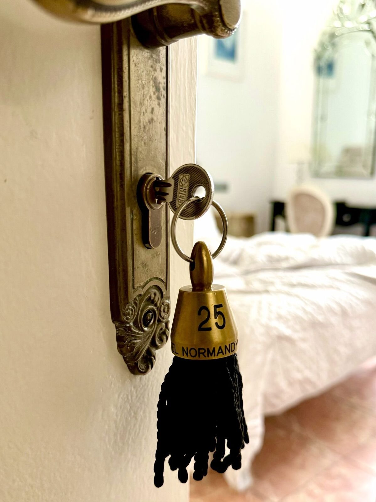 Room key with a black tassel on the door